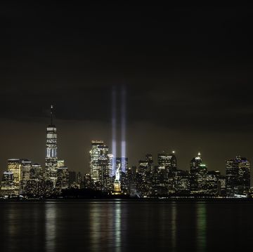 9 11 quotes new york skyline at night with two beams representing the world trade center