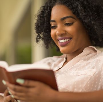 bible verses about joy  woman smiling reading the bible