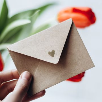 wedding card messages hand holding an open envelope with a heart on it