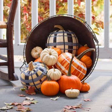 pumpkin painting ideas plaid painted pumpkins in a basket on a porch