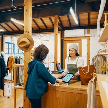 small business quotes customer checking out at cashier in a clothing store